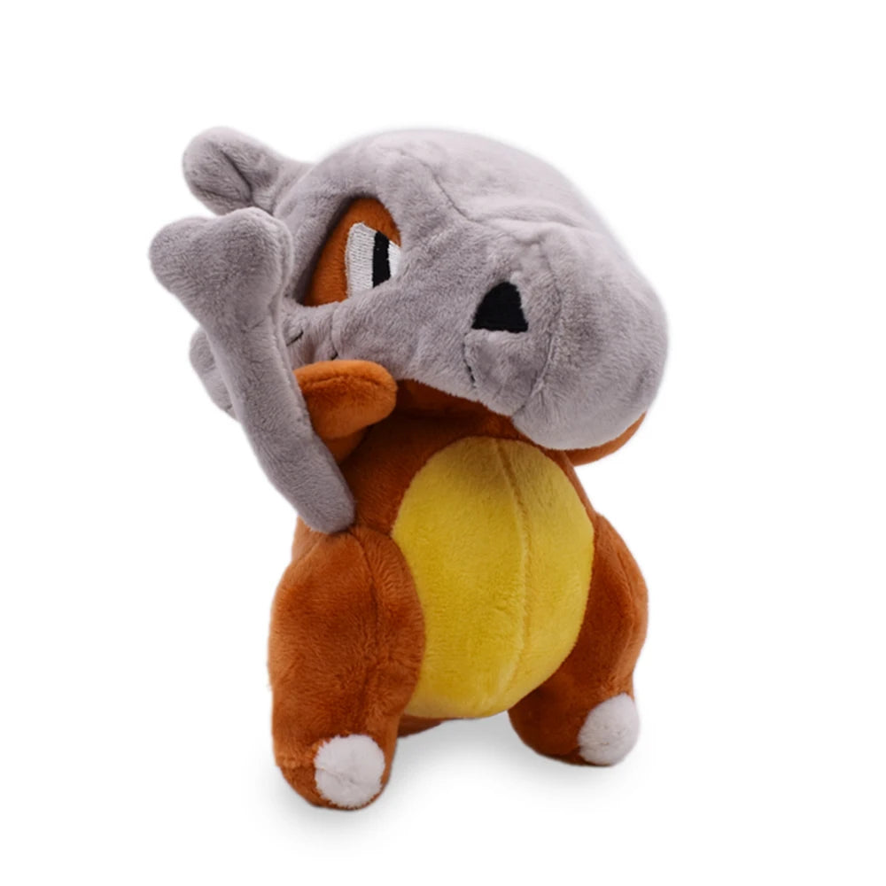 Plush toy of Pokemon Cubone character with gray head, orange body, and yellow belly on a white background showing a corner view.