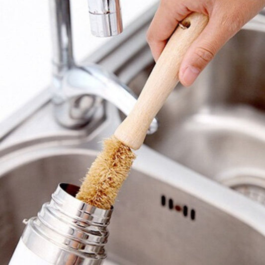 Image for a long bottle cleaning bamboo brush being used to clean a stainless steel bottle.