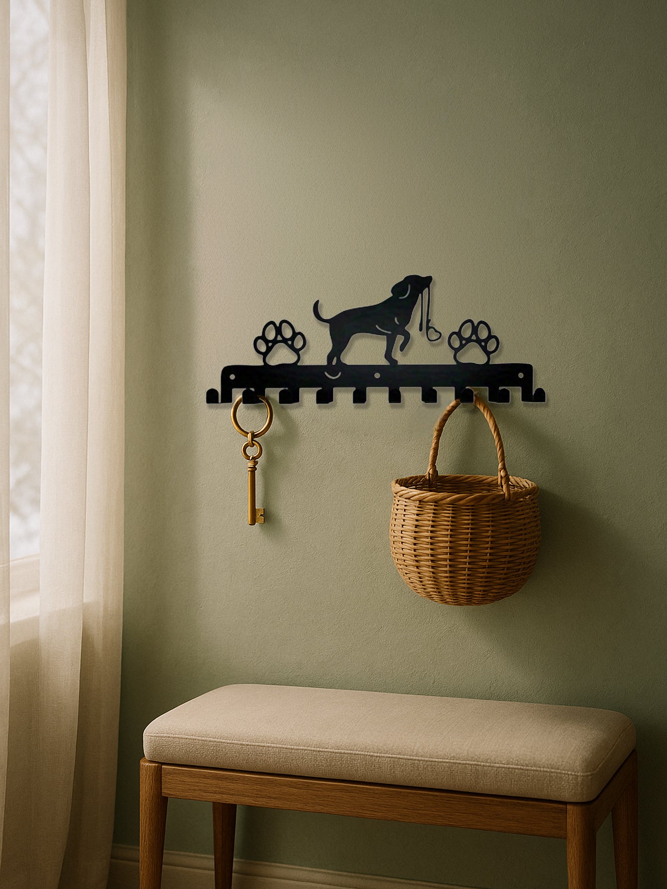 10-hook wall rack with dog and paws design, keys, and basket against a green wall with a cushioned bench.