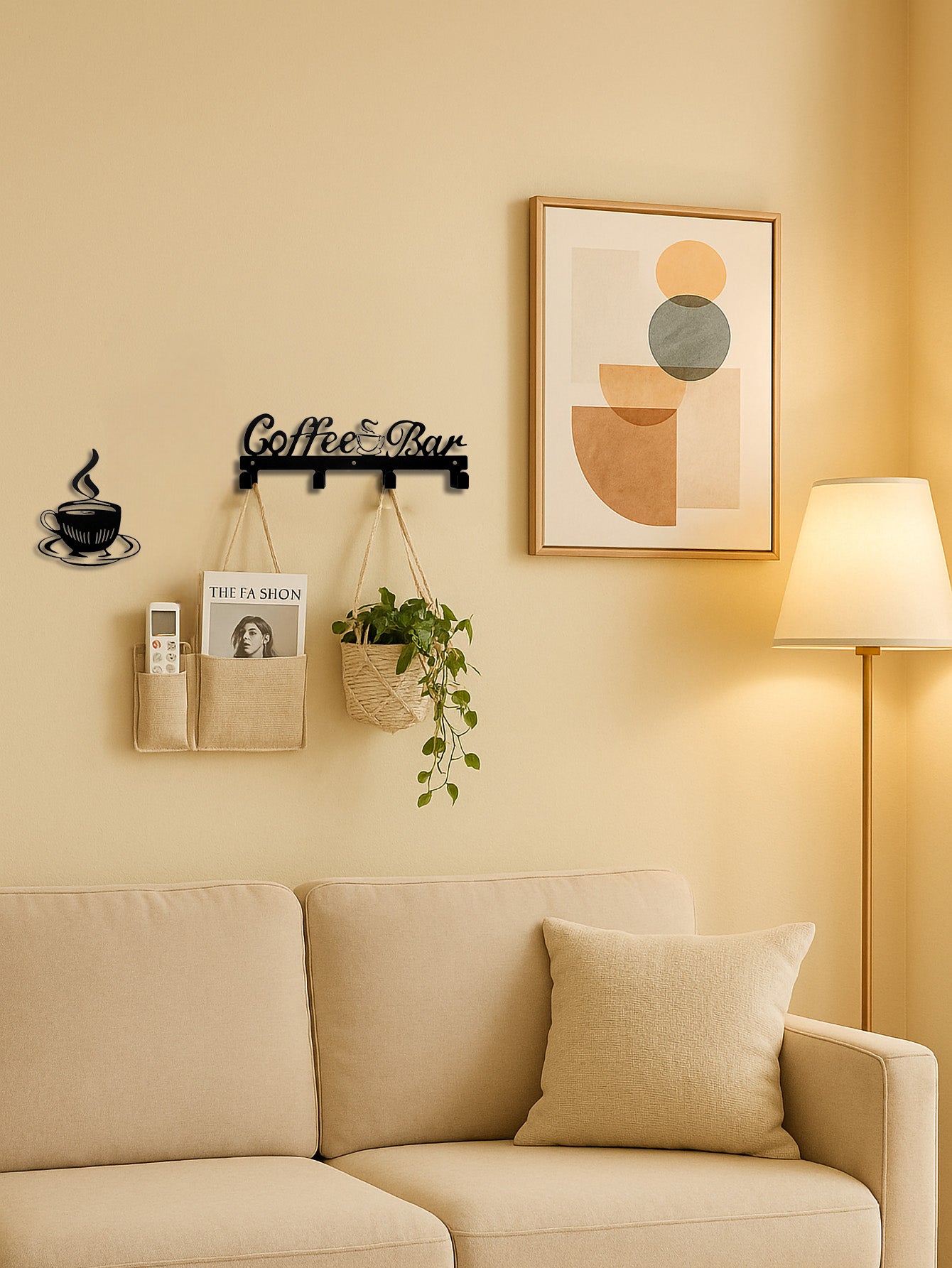 4-hook wall mounted key and coat rack with 'Coffee and Bar' text design, a separate coffee cup & plate decor piece on a beige wall with plant basket in a living room.