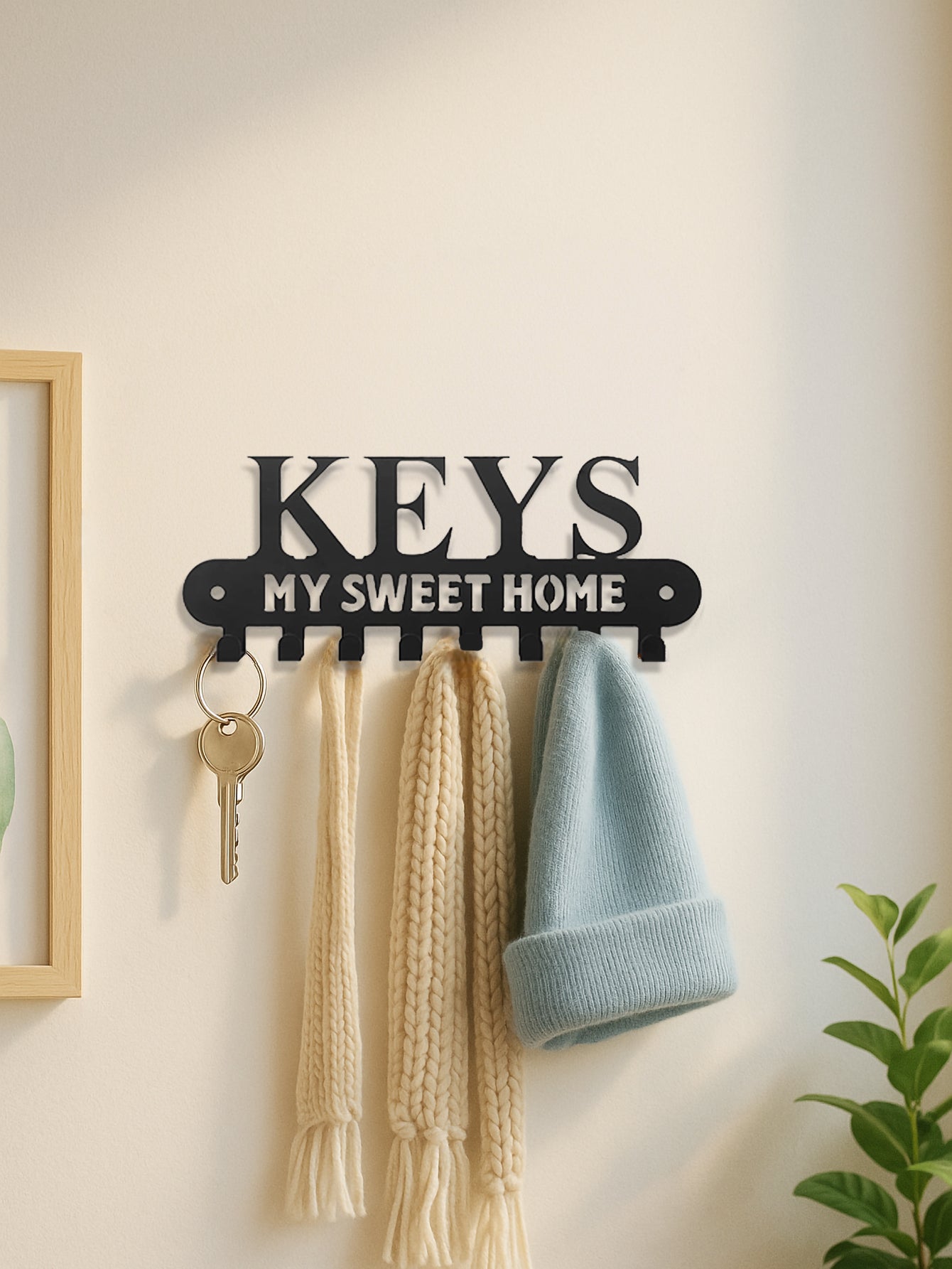 8-hook key holder with 'KEYS MY SWEET HOME' text on a wall with keys and scarves hanging from it.