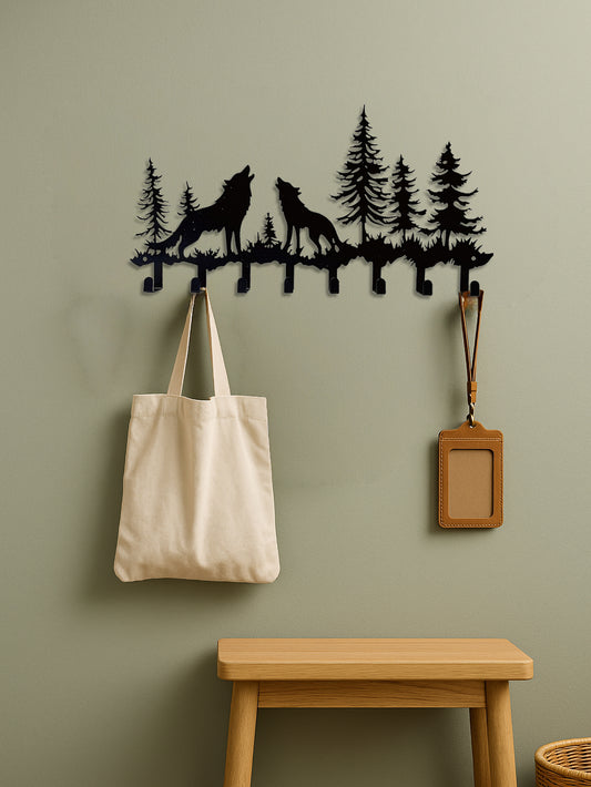 8-hook wall rack with wolves howling in forest design on a green wall with a bench and bag below.