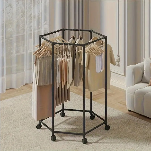 Black hexagonal garment rack with wheels, hanging clothes in a living room setting