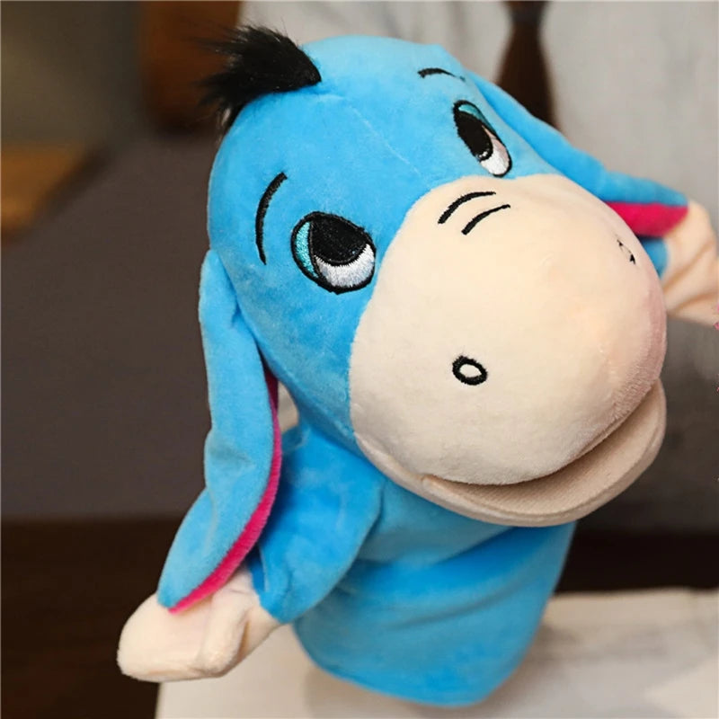 Blue donkey hand puppet with blue fur and pink inner ears on a blurred background