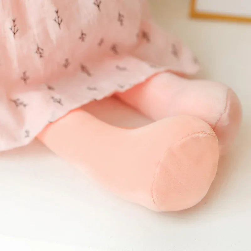 Close view of the pink bunny plush doll's feet.
