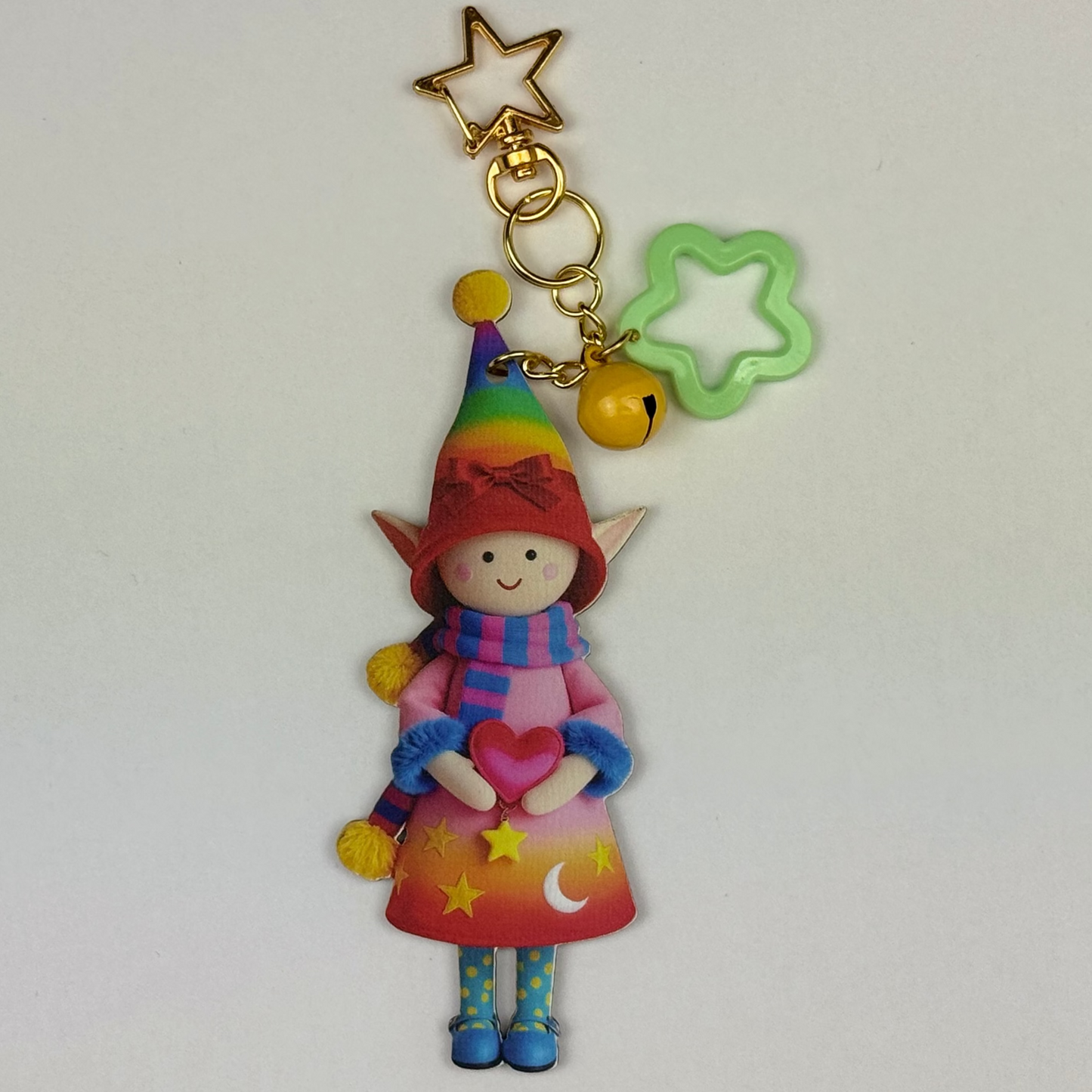 Colorful elf doll keychain with a green star-shaped charm and golden start chain & hook on a white background