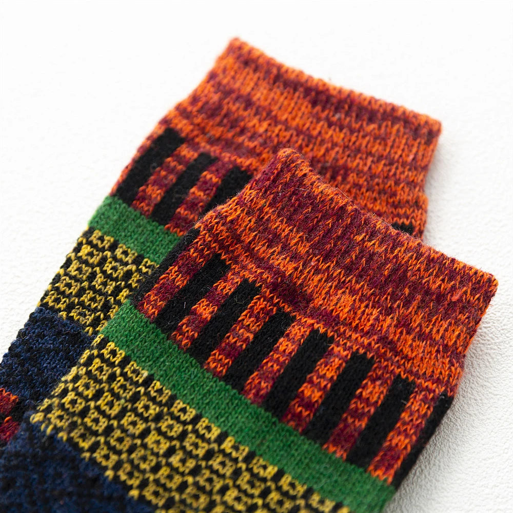 Colorful pair of wool socks with geometric pattern on a white background