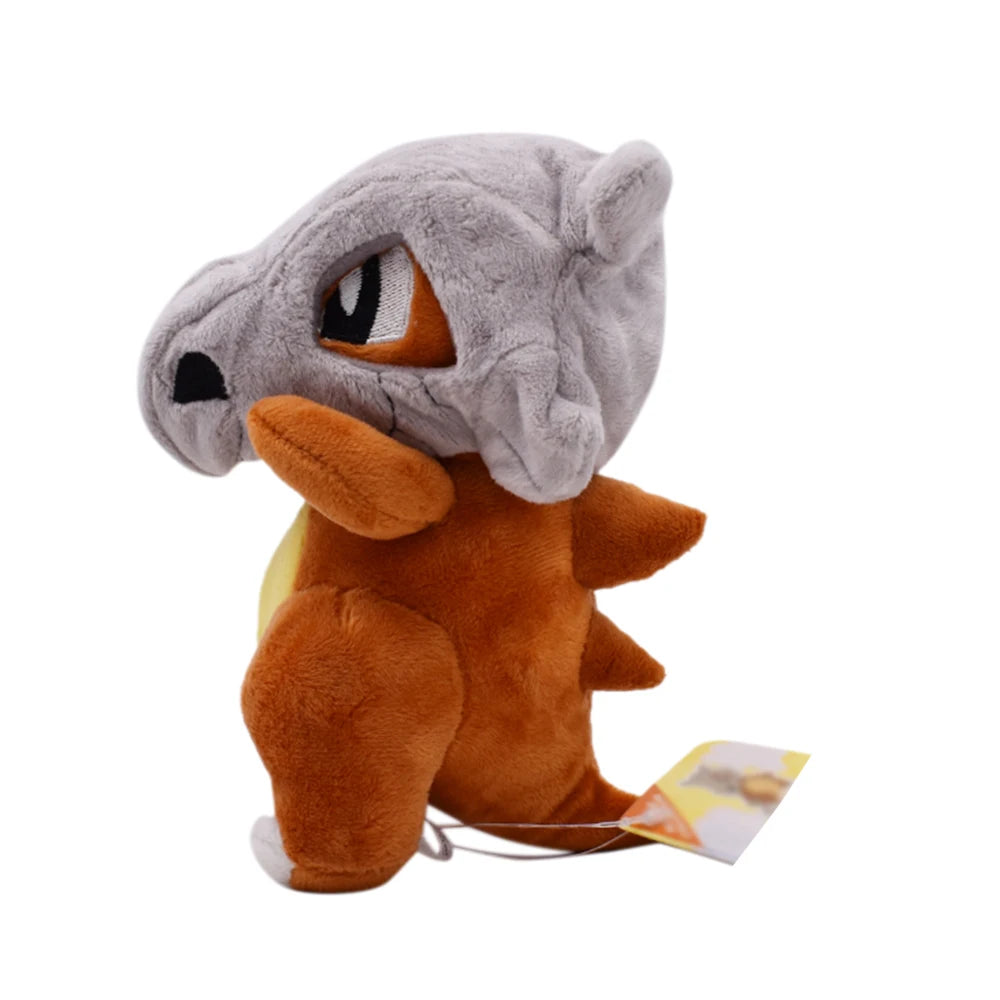 Cubone plush toy with a gray top and brown body showing the side pose on a white background