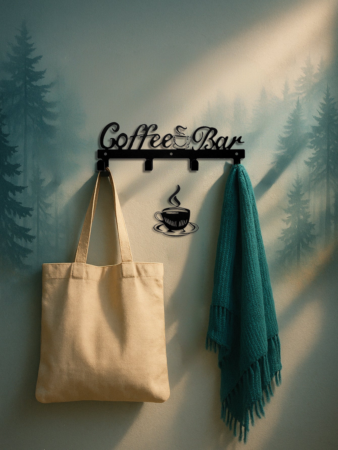 Decorative 4-hook wall mounted key and coat rack with 'Coffee Bar' text design, a separate coffee cup decor below it, holding a beige tote bag and teal scarf against a forest background.