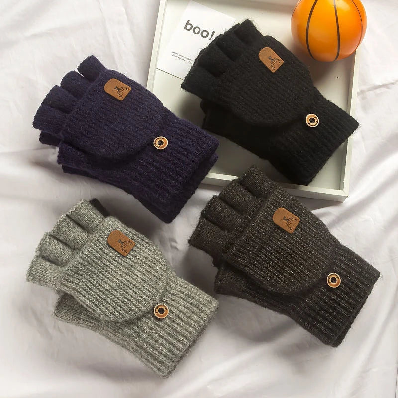 Four pairs of knitted fingerless gloves in black, gray, and navy on a white surface.