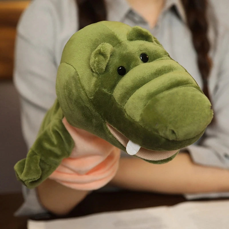 Green plush alligator hand puppet held by a person