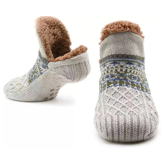Pair of gray fuzzy slipper socks with brown fur lining on a white background