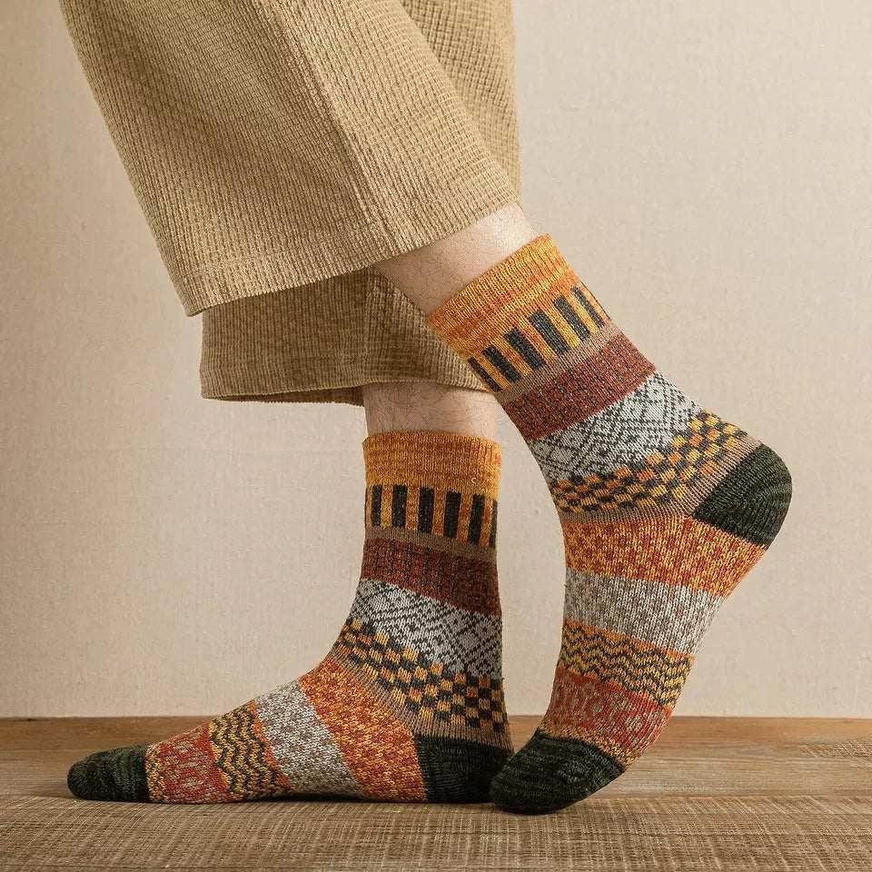 Patterned socks worn with beige pants on a neutral background