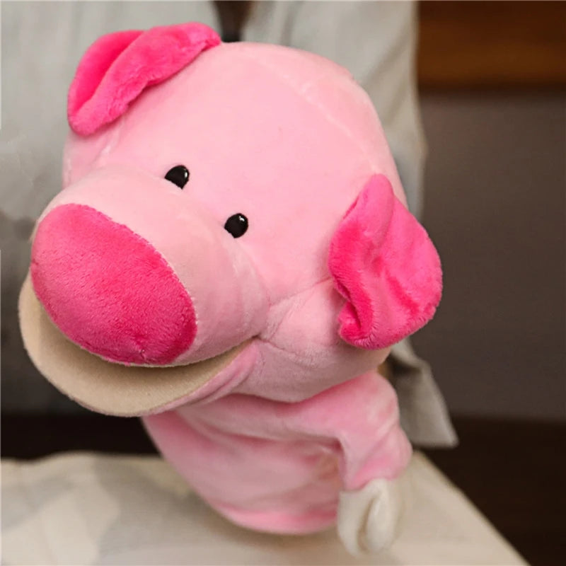 Pink plush pig hand puppet with a blurred background