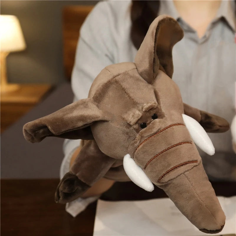 Plush elephant hand puppet held by a person in a home setting