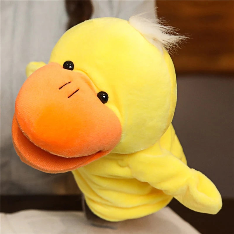 Plush hand puppet duck with a yellow body and orange beak on a blurred background