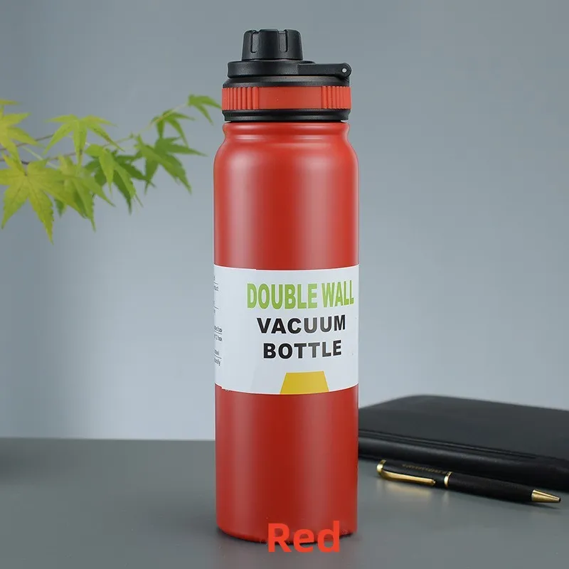 Image for the red stainless steel double wall insulated water bottle placed upright on the table.