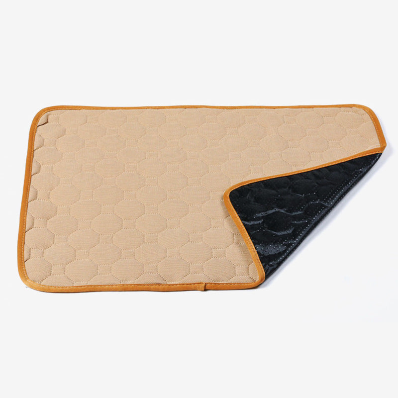 Image for reusable washable anti-slip pet pee pad in beige color. A corner is folded upwards to show the anti-slip bottom of the pad.
