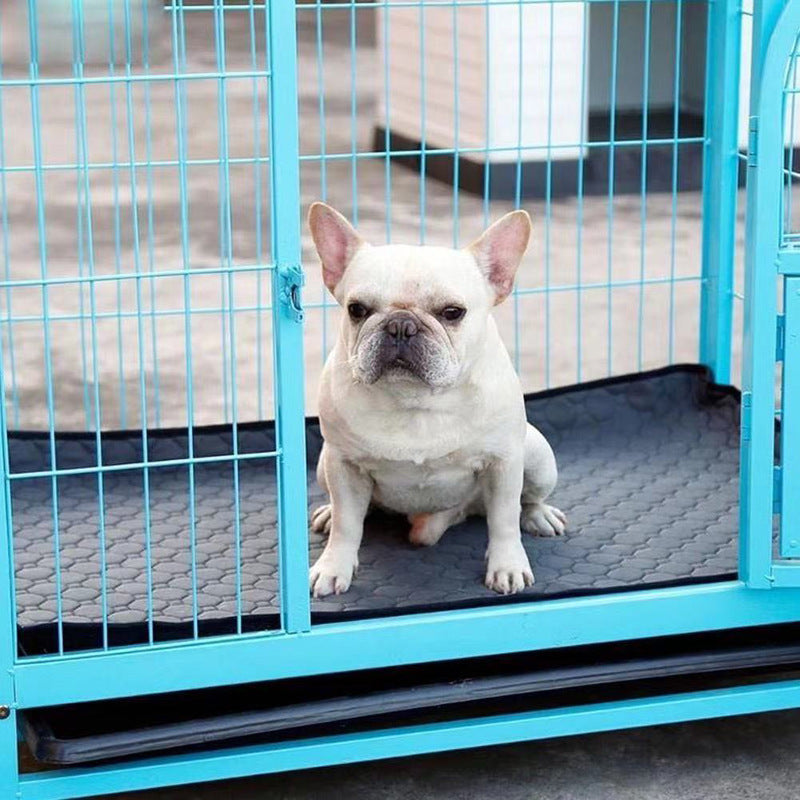 Image for reusable washable anti-slip pet pee pad in dark grey color spread inside a pet cage. A white dog is shown sitting on the pad inside the cage.