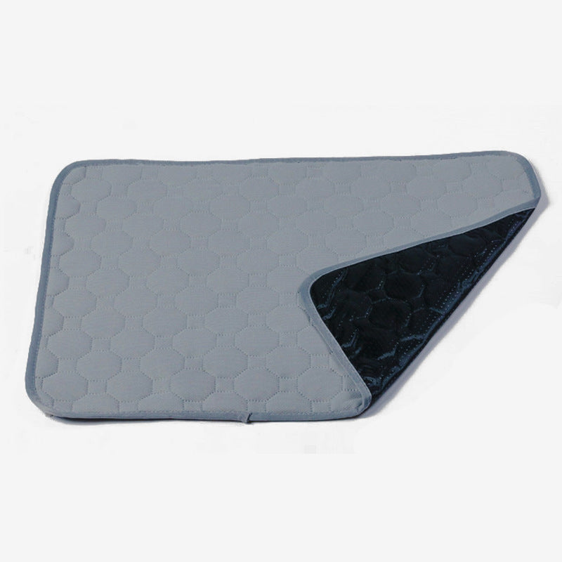 Image for reusable washable anti-slip pet pee pad in light grey color. A corner is folded upwards to show the anti-slip bottom of the pad.
