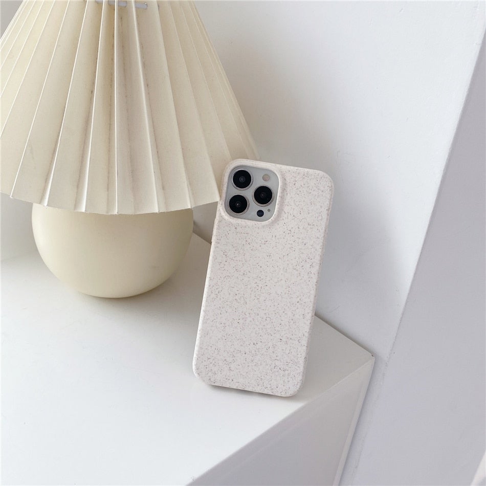 Image for wheat straw phone case for iPhone with the phone placed on table. Color of the case is white textured.