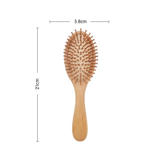 Image of oval head bamboo wooden hair brush with marked dimensions as 21cm full brush length and 5.3cm wide brush head.
