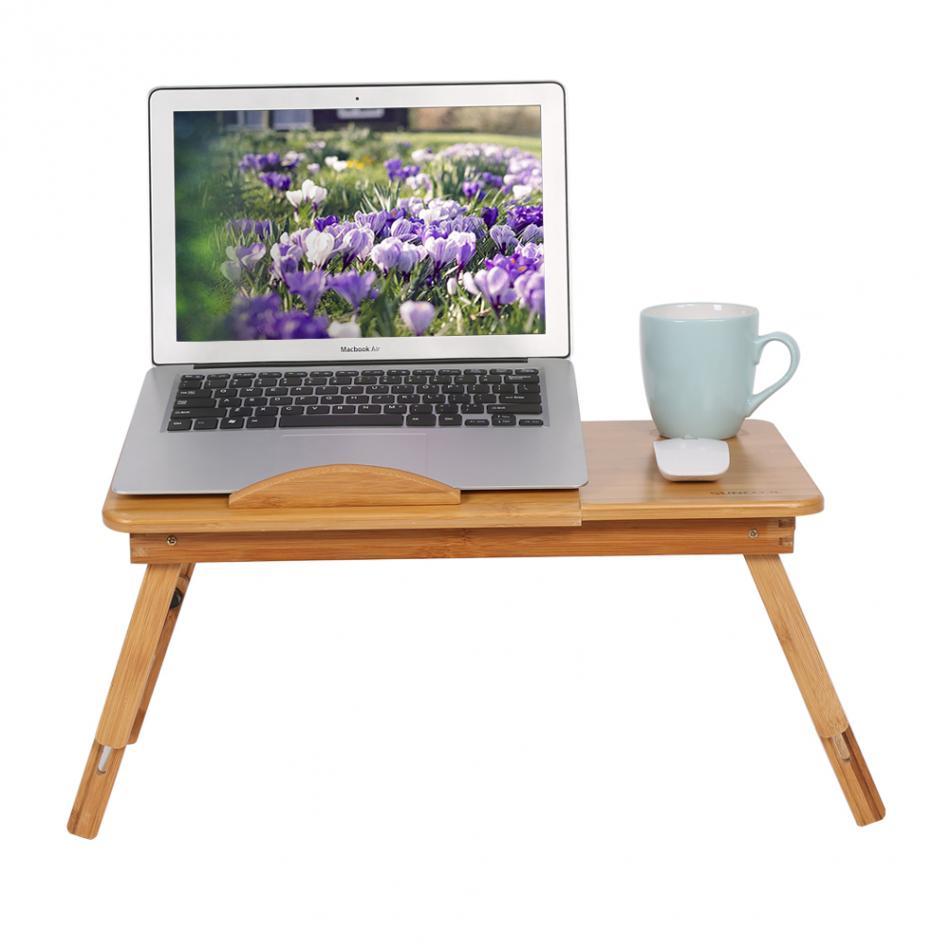 Image with laptop computer and coffee cup on the adjustable laptop stand.