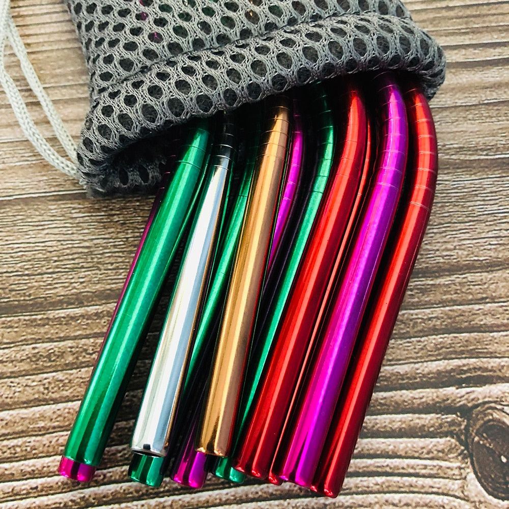 Image for a few reusable stainless steel straws in mixed color inside the pouch placed on a wooden board.