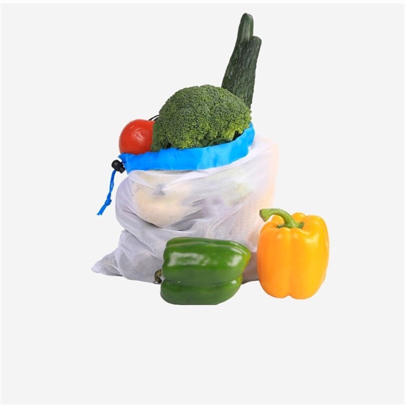 Image for reusable grocery bags filled with vegetables. Two bell peppers are placed next to the bag.