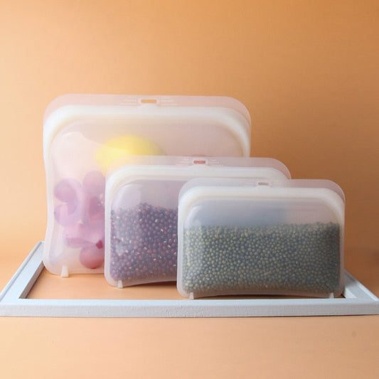 Image for reusable ziplock bags, pack of three. The large bag is shown as containing vegetables and the smaller bags are shown containing dry beans.