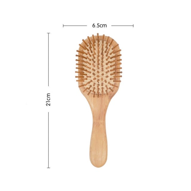 Image of rounded head bamboo wooden hair brush with marked dimensions as 21cm full brush length and 6.5cm wide brush head.