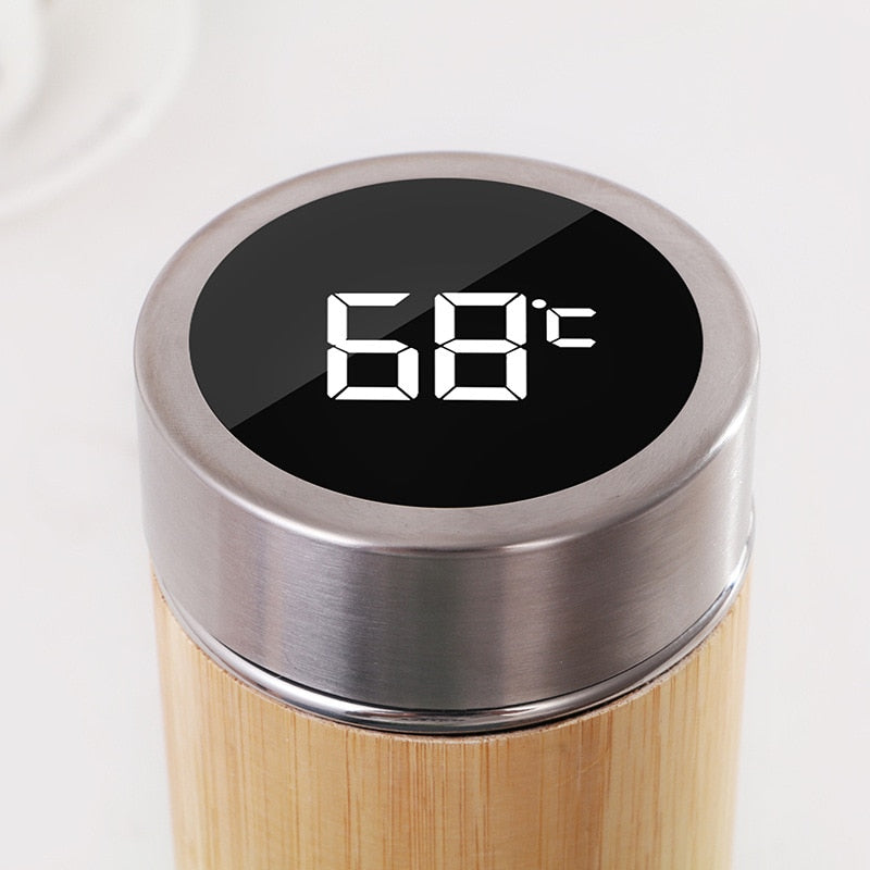 Image for stainless steel thermos flask showing its upper half only with lid placed on it. The lid displays the temperature of beverage on its top.